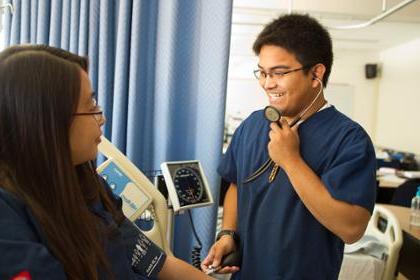 Nursing student takes another student's blood pressure